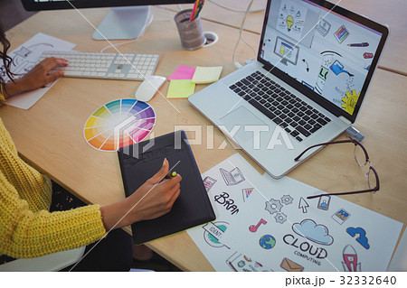 Female editor using digitizer on desk in office Female editor using digitizer on desk in office 32332640