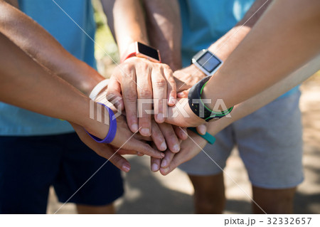 Marathon athletes forming a hands stack Marathon athletes forming a hands stack 32332657
