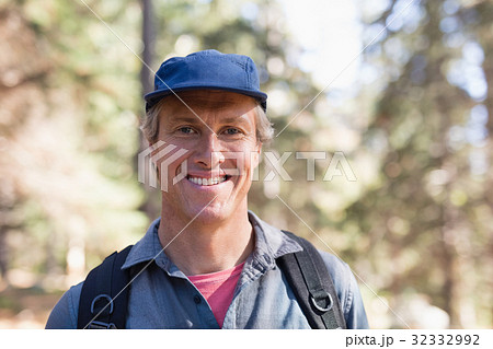 Portrait of happy hiker wearing blue cap 32332992