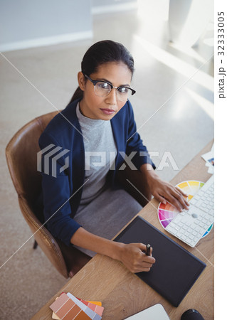 Portrait of confident graphic designer working at desk Portrait of confident graphic designer working at desk 32333005
