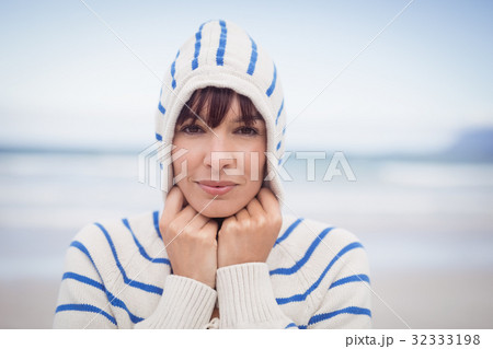Portrait of woman wearing hooded sweater during winter Portrait of woman wearing hooded sweater during winter 32333198