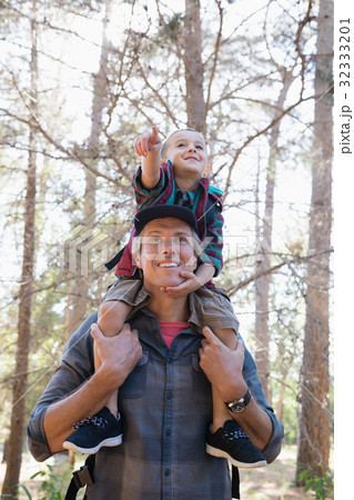 Low angle view of father carrying son on shoulders Low angle view of father carrying son on shoulders 32333201
