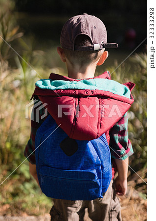 Rear view of hiker standing in forest Rear view of hiker standing in forest 32333298
