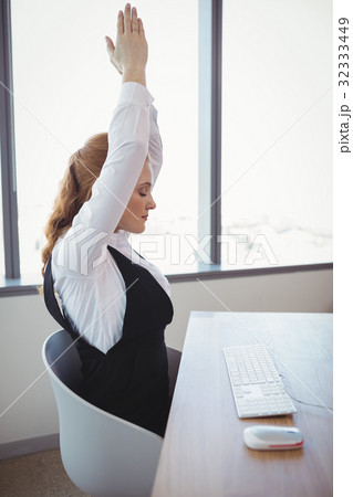 Executive exercising at desk 32333449