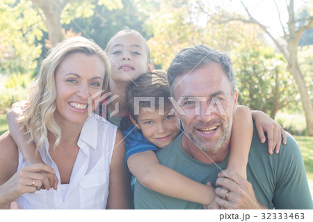 Happy family in park on a sunny day Happy family in park on a sunny day 32333463