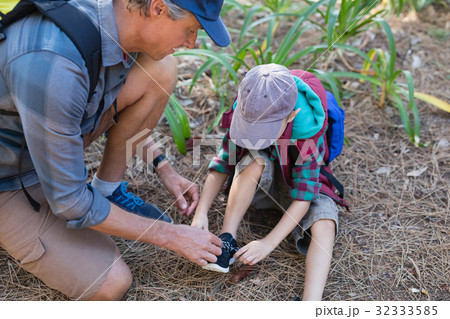 High angle view of man tying shoelace of son 32333585
