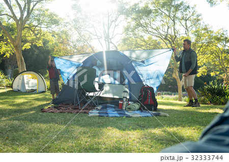 Father and son setting up a tent Father and son setting up a tent 32333744
