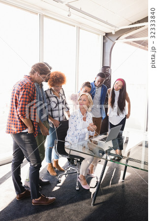 Businesswoman interacting with creative team 32333840