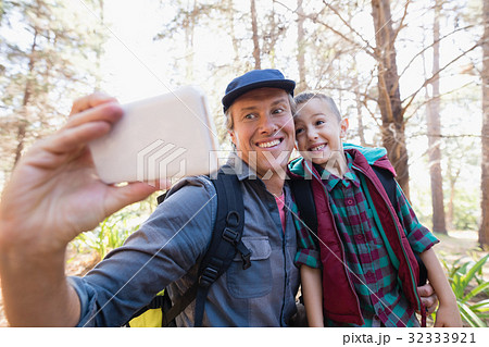 Happy father and son taking selfie from mobile phone Happy father and son taking selfie from mobile phone 32333921