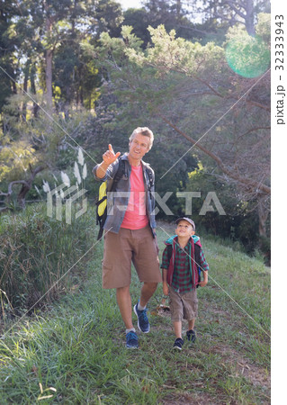 Happy father pointing while hiking with son Happy father pointing while hiking with son 32333943