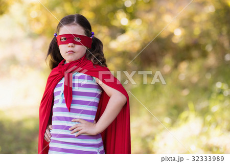 Little girl wearing superhero costume at campsite 32333989