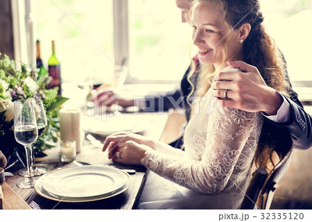 Groom Holding Bride Closely on Wedding Reception 32335120