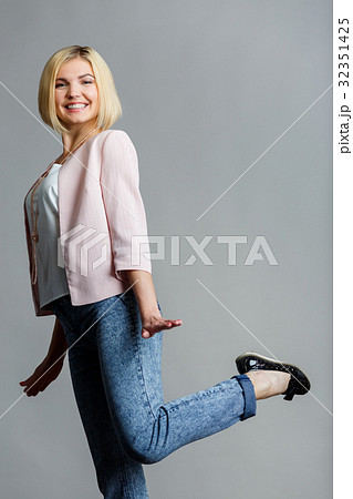 Woman raised leg in studio Woman raised leg in studio 32351425
