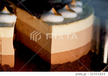 four layer cake with shades of brown.Here cream to 32351833