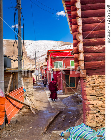 Tibetan buddhist monks walking in a nerrow street Tibetan buddhist monks walking in a nerrow street 32352109