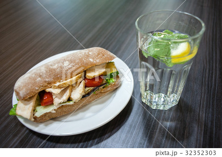 Sandwich on a plate and a glass of water Sandwich on a plate and a glass of water 32352303