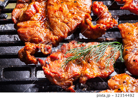 Grilling pork steaks on barbecue grill Grilling pork steaks on barbecue grill 32354492