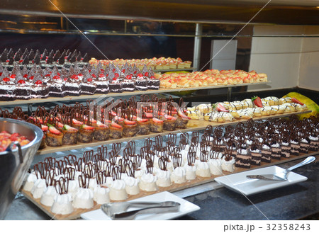 Delicious cream cakes and fruit in the hotel 32358243