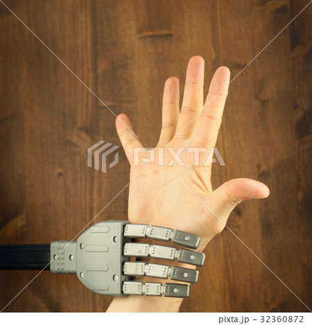 robot and human hand in a battle for work 32360872