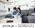 Happy couple online shopping at home 32362121