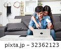 Happy couple online shopping at home 32362123