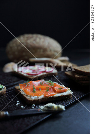 Sandwich with cereals bread smoked salmon beetroot and cucumber on dark marble background Sandwich with cereals bread smoked salmon beetroot and cucumber on dark marble background 32364527