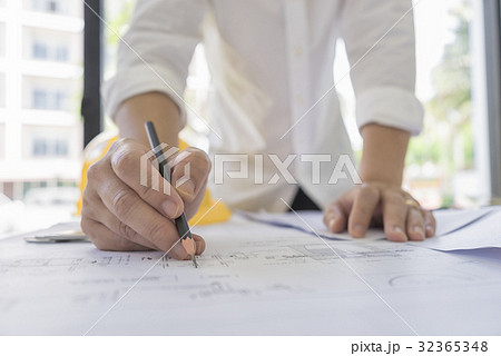 Engineer sketch architectural project on blueprint 32365348