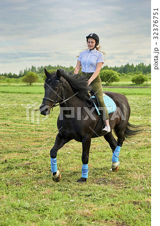 Pretty little girl riding a horse 32376751