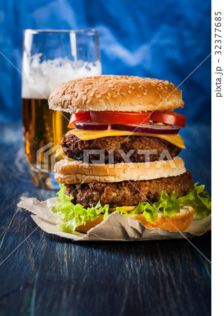 Hamburger on paper with beer Hamburger on paper with beer 32377685