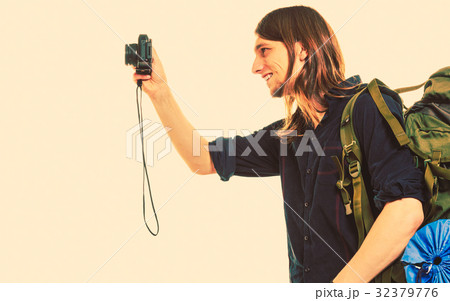 Man tourist backpacker taking photo with camera. 32379776