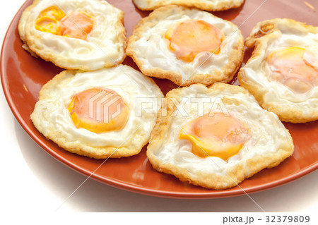 Many fried eggs on the plate, ready to serve Many fried eggs on the plate, ready to serve 32379809