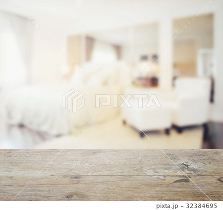 wooden table top with blur of modern bedroom 32384695