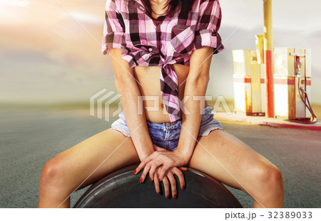part of  woman near gas station 32389033