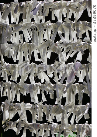 Lucky papers at Buddhist temple in Japan 32399070
