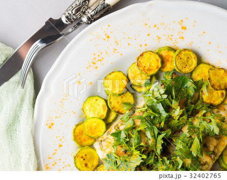 Stock fish fillet with turmeric courgettes Stock fish fillet with turmeric courgettes 32402765