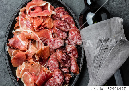 Spanish ham serrano, salami and bottle of red wine 32408497