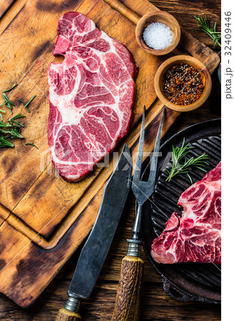 Raw marbled beef steaks on wooden cutting board 32409446