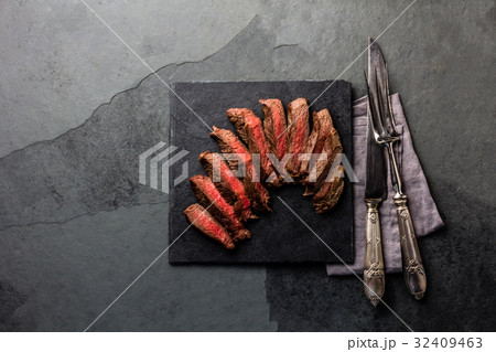 Medium rare beef steak on slate board, vintage Medium rare beef steak on slate board, vintage 32409463