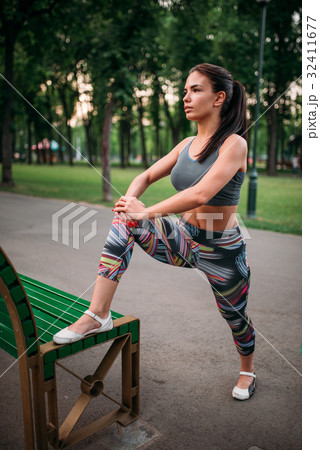 Athletic woman exercises, fitness training in park Athletic woman exercises, fitness training in park 32411677