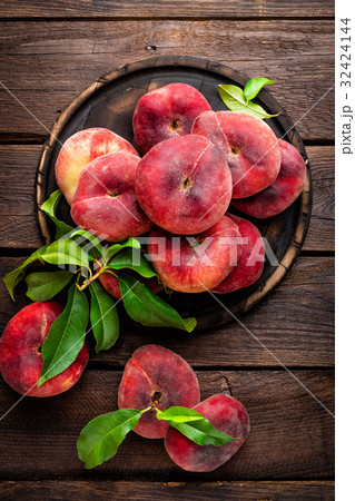 Peach, saturn or donut peaches with leaves Peach, saturn or donut peaches with leaves 32424144