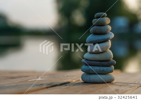 Zen Balancing Pebbles Next to a Misty Lake 32425641