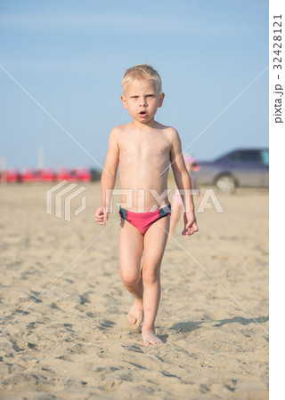 Cute baby boy walking on sandy beach near the sea Cute baby boy walking on sandy beach near the sea 32428121