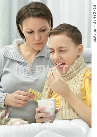 Mother taking care of son 32430718