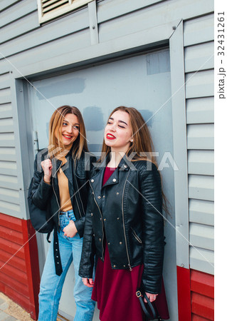 Two attractive  girl friends standing together 32431261