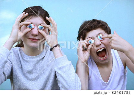 boy and girl with jujube marshmellow eyes smiling open mouth close up portrait boy and girl with jujube marshmellow eyes smiling open mouth close up portrait 32431782