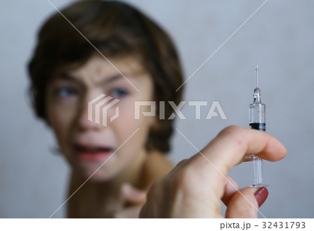 teenager boy afraid of syringe injection vaccination  32431793