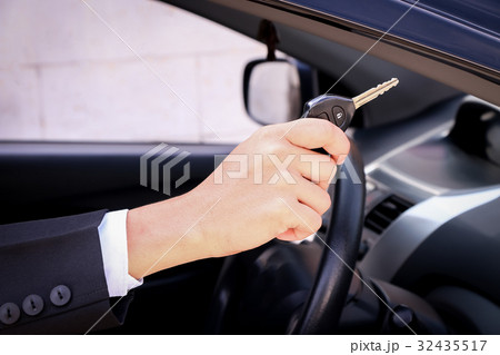 Business man smiling showing key 32435517