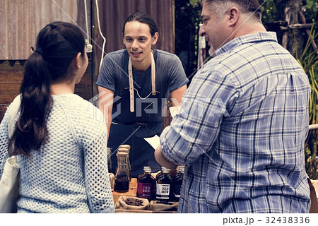 Man Selling Coffee Fresh Brew to People at Market Man Selling Coffee Fresh Brew to People at Market 32438336