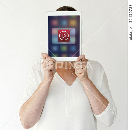 Woman holding network graphic overlay digital device covering face Woman holding network graphic overlay digital device covering face 32439788