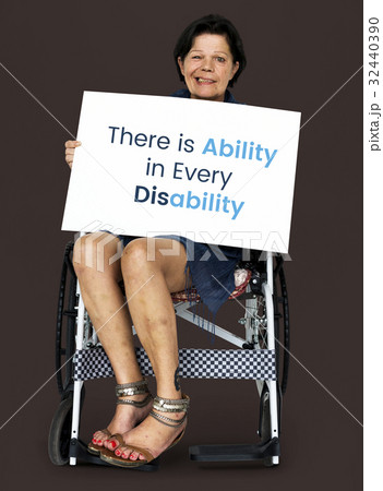Senior adult woman on wheelchair holding motivation banner 32440390
